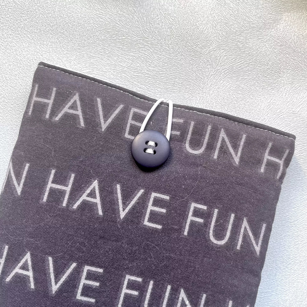 Zoom sur le bouton de récupération de la pochette à livre upcyclés noir